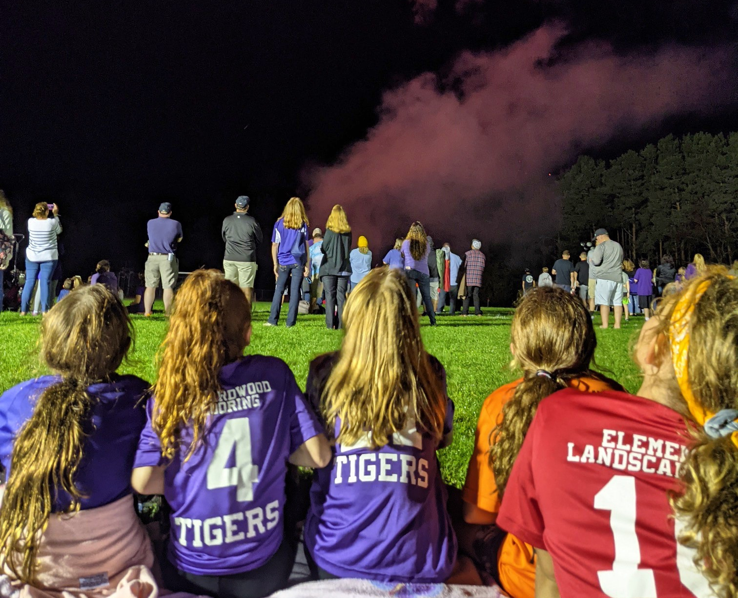 students sitting down watching fireworks