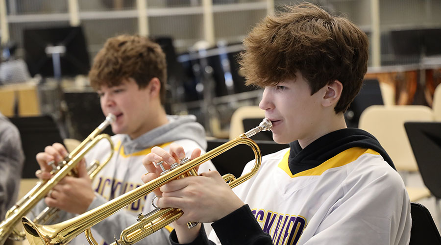 student athlete musicians with trumpets