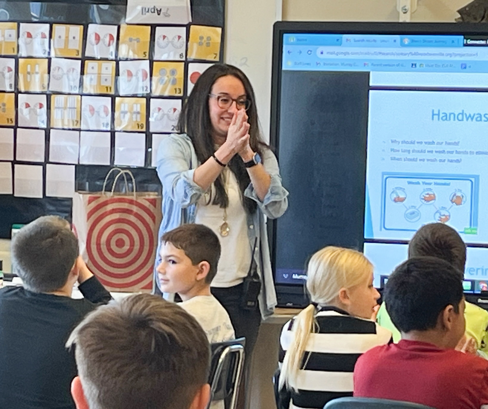 Nurse teaches students about hand washing.