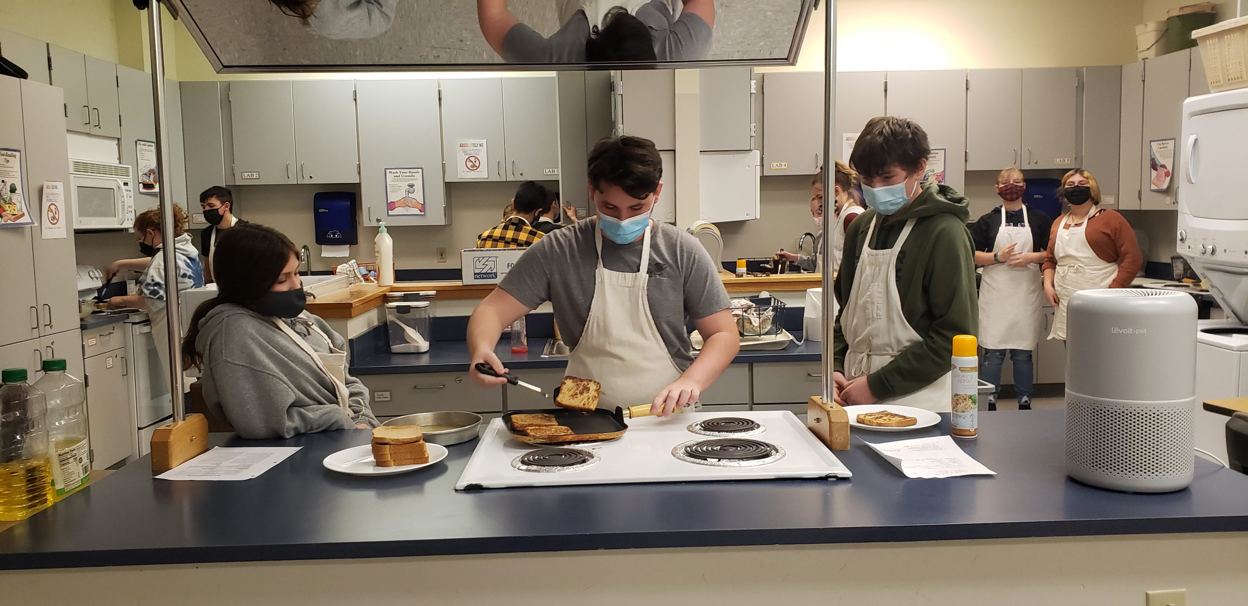 students cooking breakfast in a food prep lab