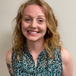 woman leaning forward smiling at camera