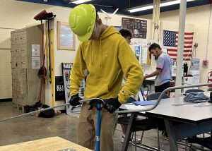 Voorheesville senior Shea dons a construction helmet while working on a construction project