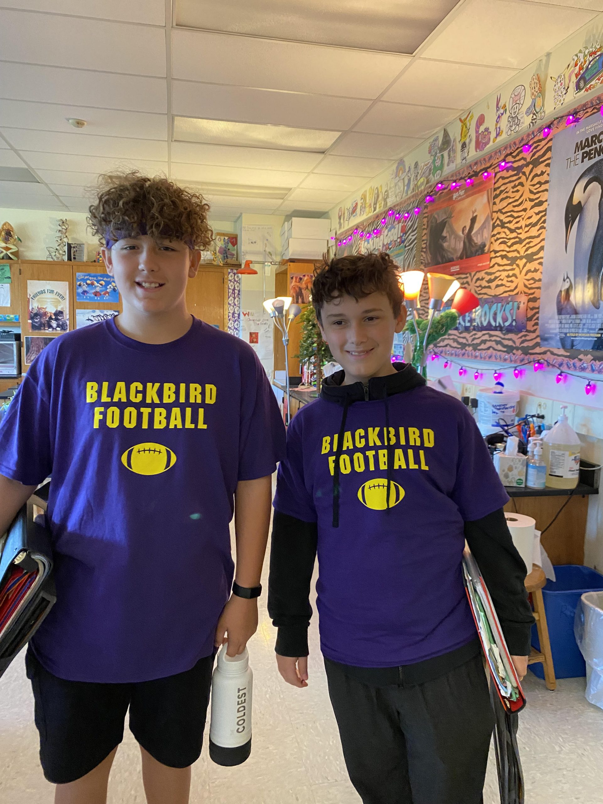 A photo of two middle schoolers in Blackbird Football shirts