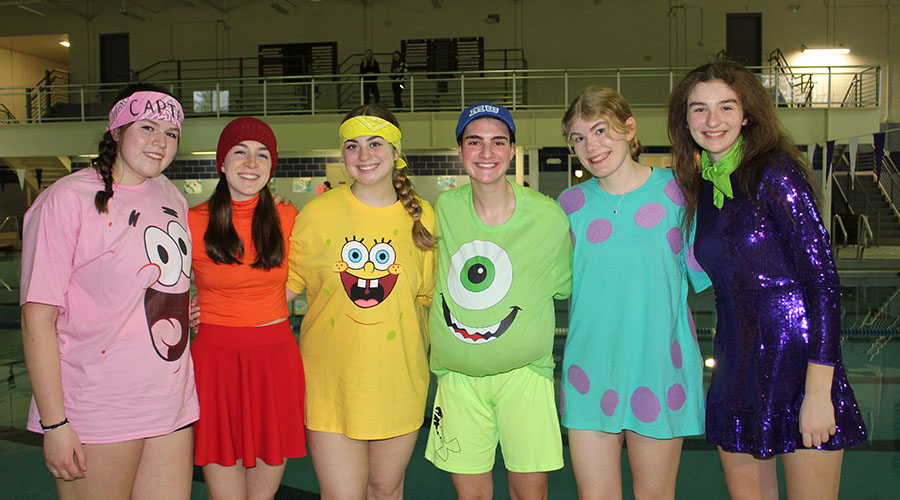 Six students, wearing Spongebob Squarepants themed clothing, smile toward the camera.