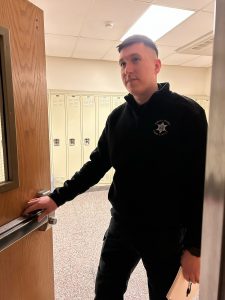Investigator tests the latch on a door at Voorheesville Central School District.