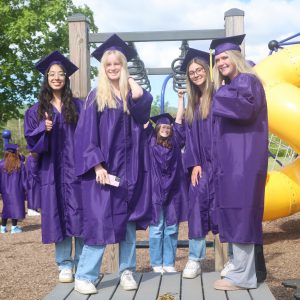 Students in cap and gown on playground