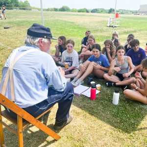 Civil War re-enactor talks to a group of students.