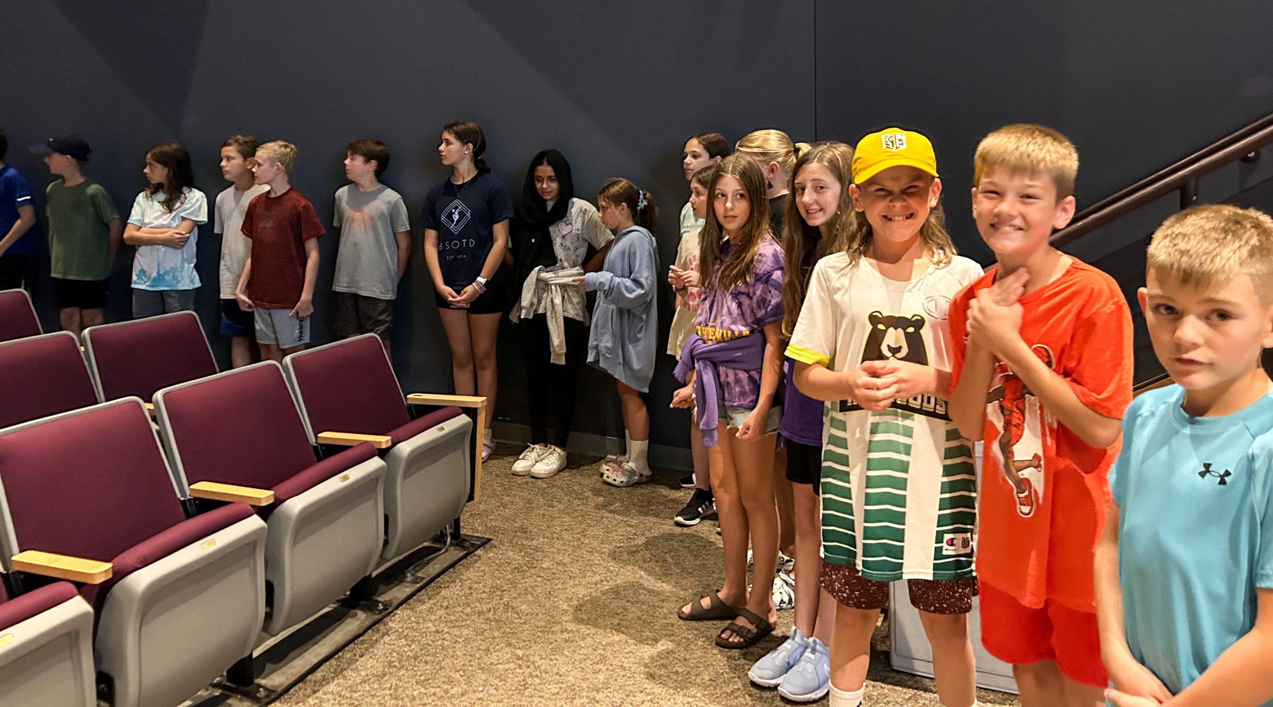 A line of students in performing arts center.
