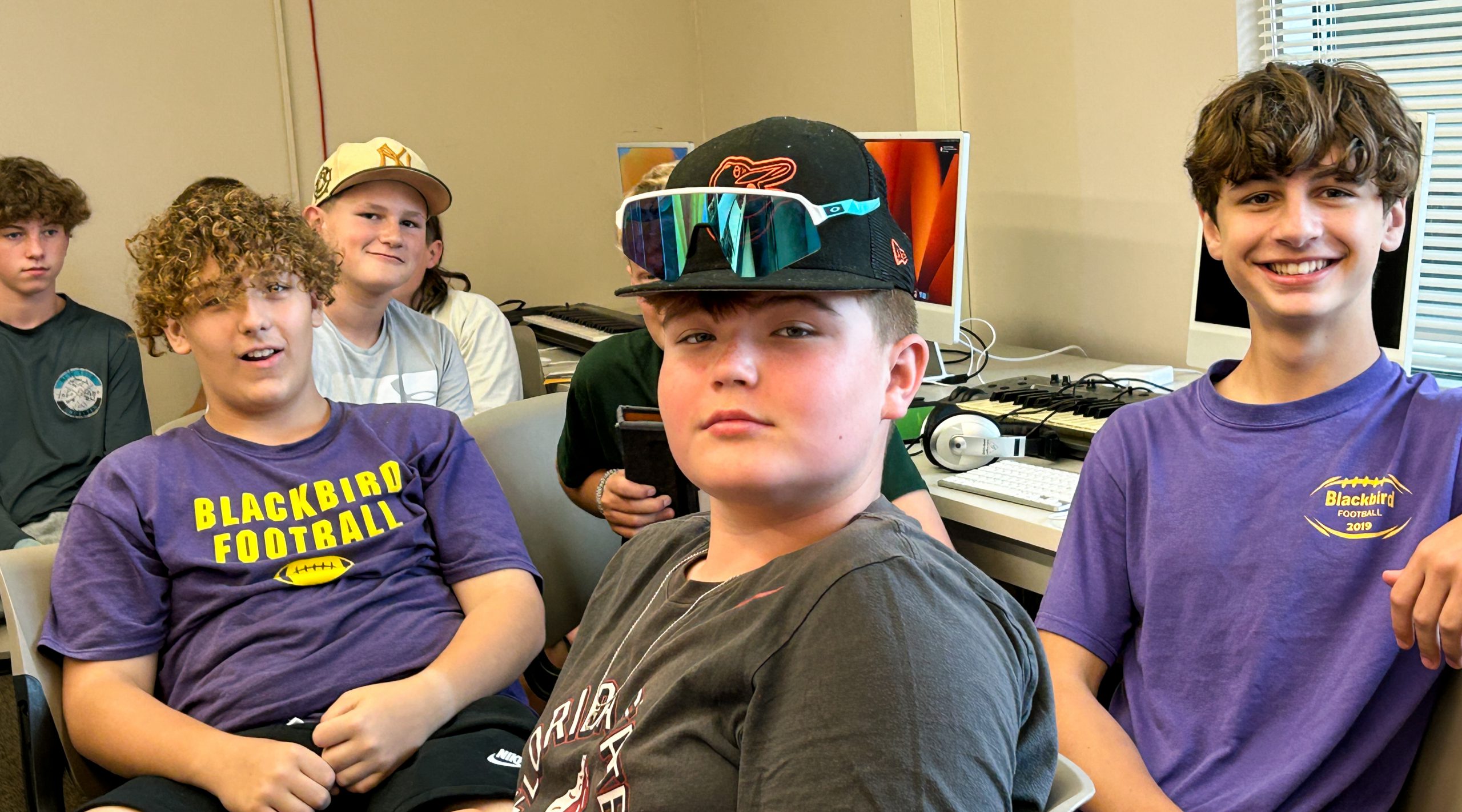Group of middle school boys sitting in classroom
