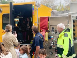 Firefighters with students.