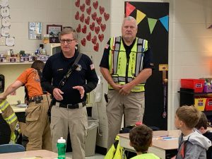 Firefighters with students .