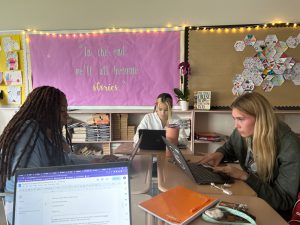 Three students sit together in class