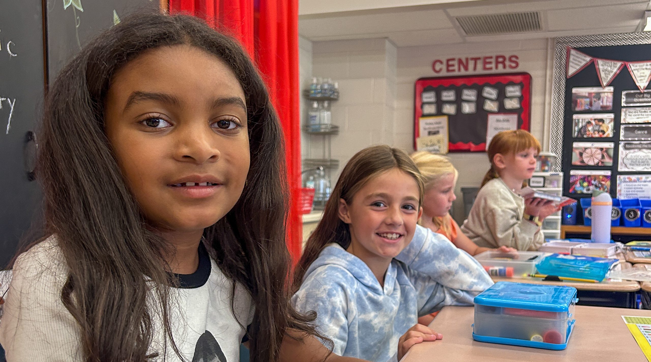 Elementary students at desks in classroom.