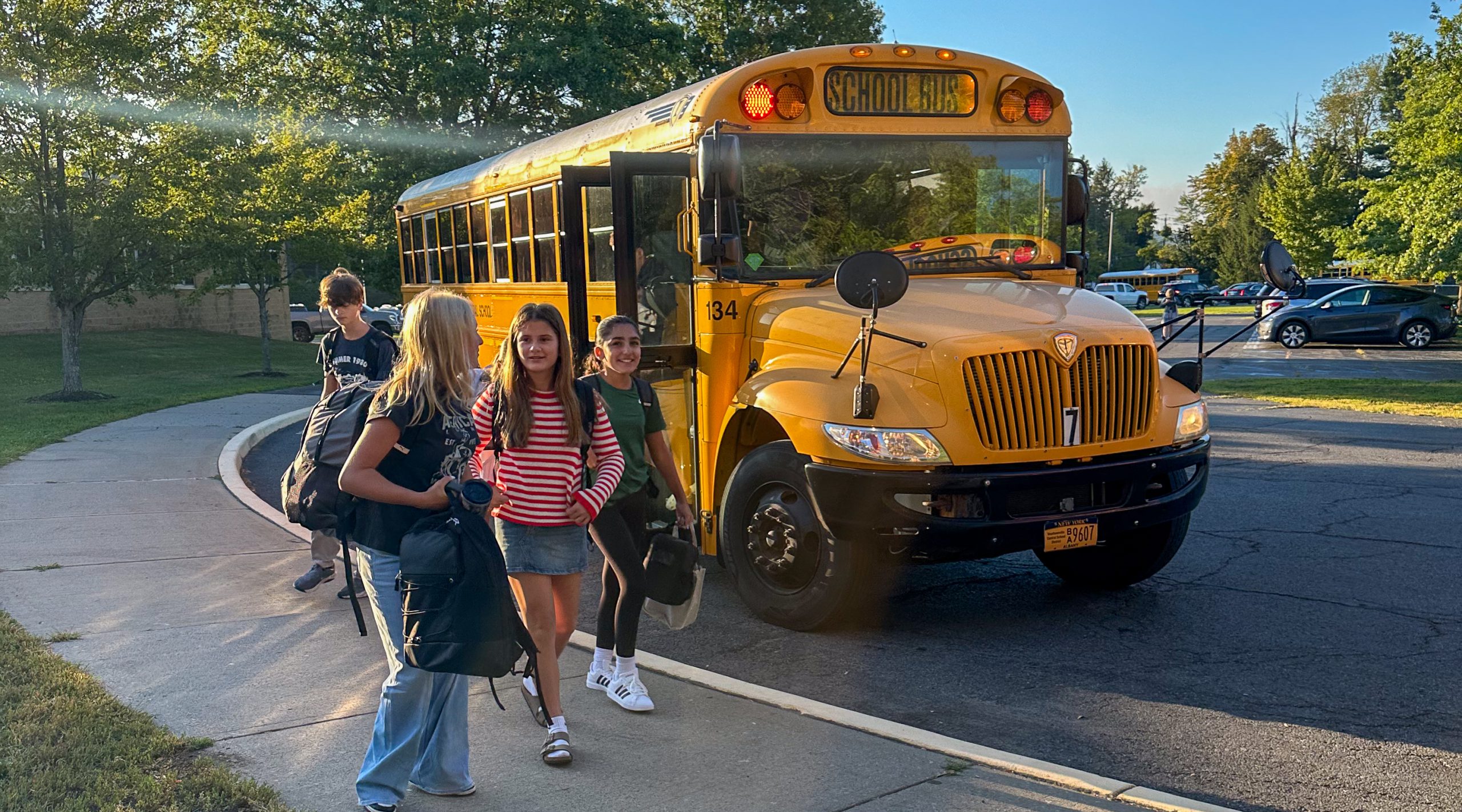 Middle school students near bus.