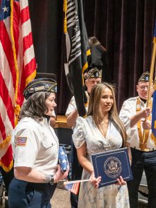 Members of Greenville American Legion Color Guard stand with a new citizen.