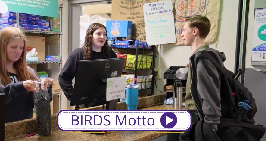 Two students work behind the counter of the Blackbird Cafe. Another student places an order. Birds Motto and play button.